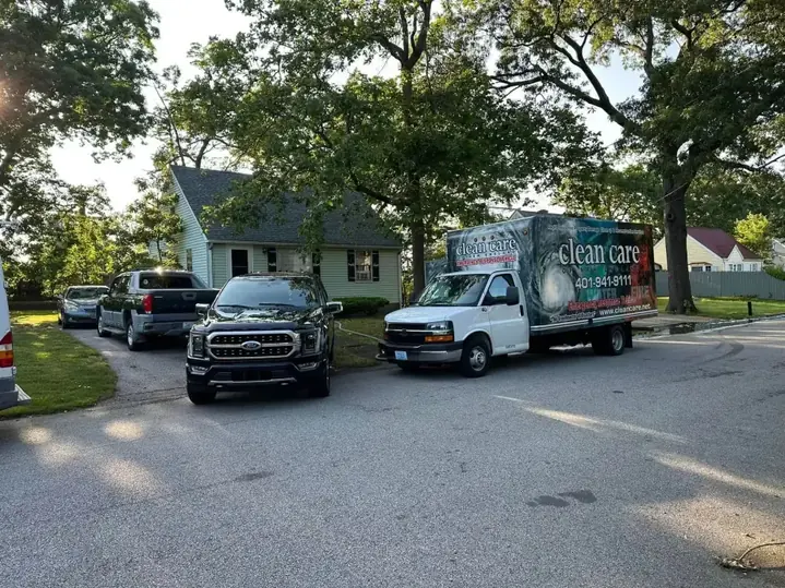 Branded Clean Care of New England emergency response box truck parked on a residential street