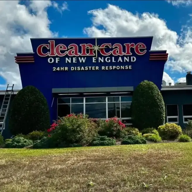 Clean Care of New England headquarters building in Warwick, Rhode Island, with its navy 24HR Disaster Response sign and roses at the entrance